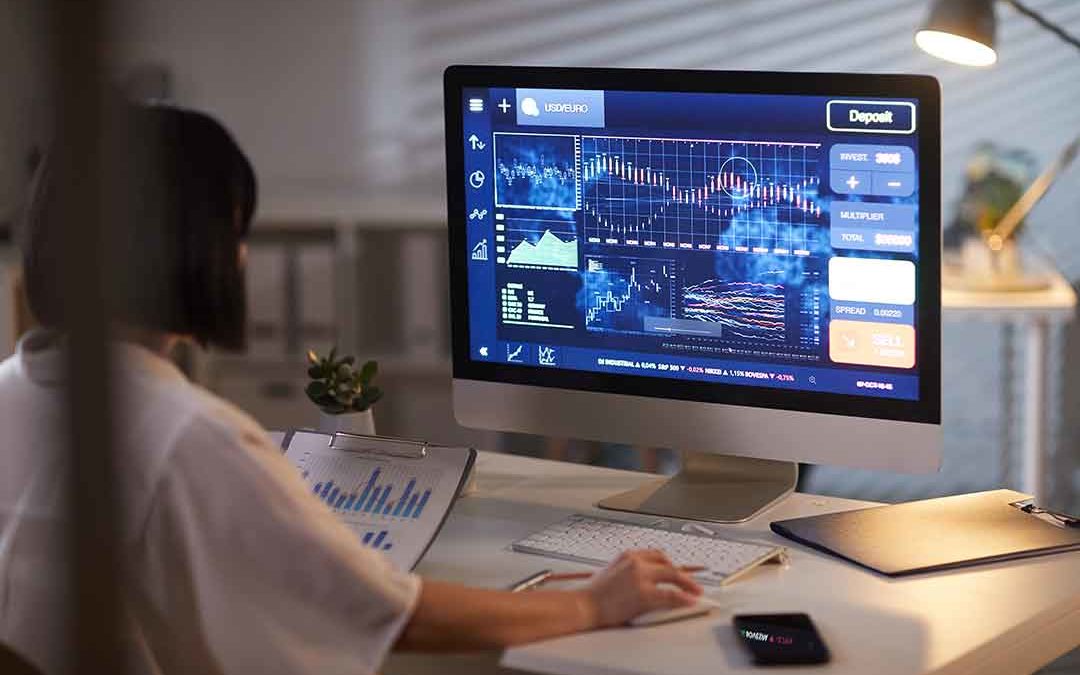 woman analyzing a stock chart on a computer screen, identifying key trends and market movements