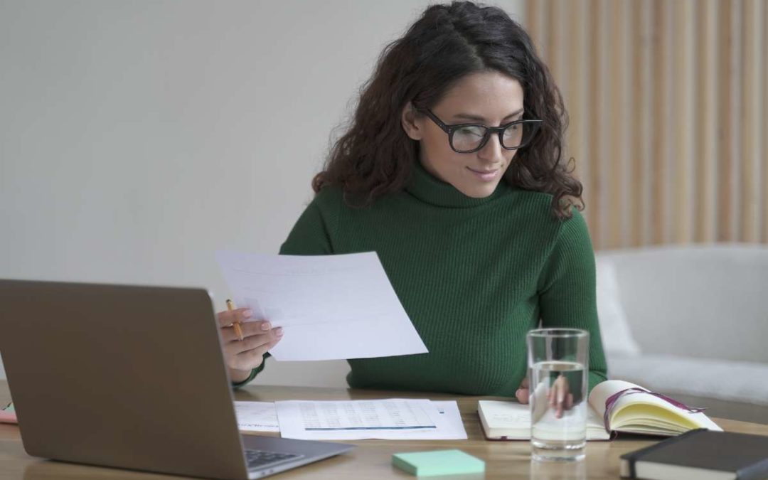 A financial planner explaining a detailed budget worksheet to a client, showing a breakdown of income and expenses on a laptop screen