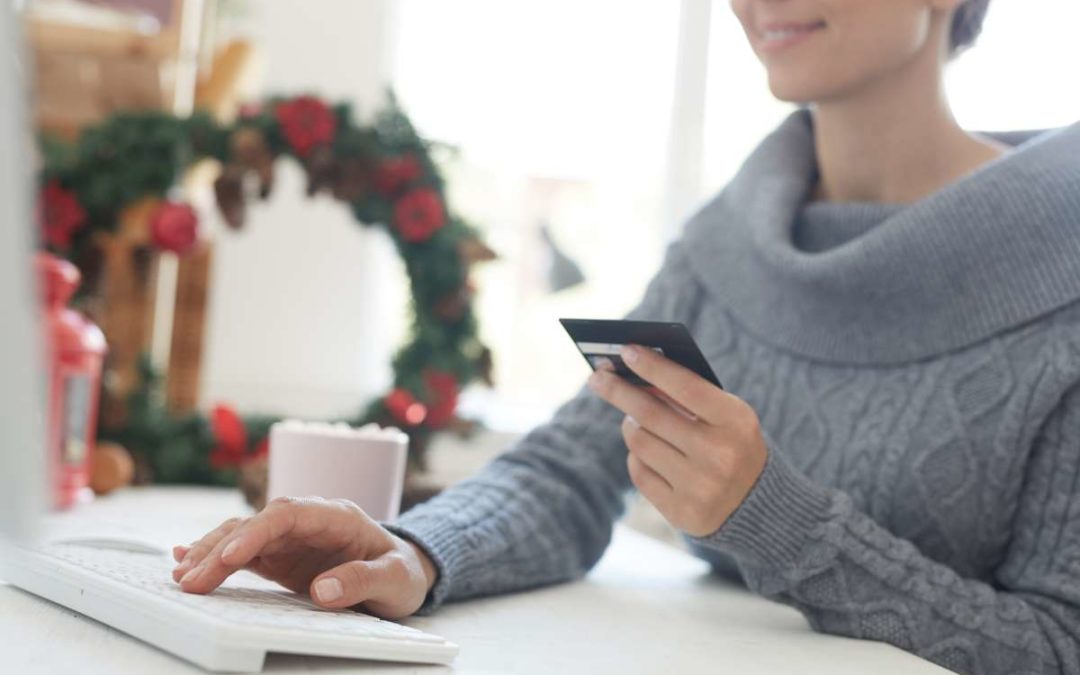 Financial planner reviewing end-of-year budget and tax strategies on a laptop with documents and calculator