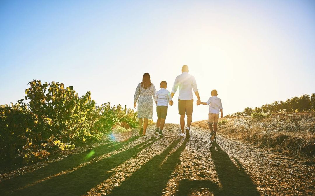 A diverse, multi-generational blended family smiling together outdoors